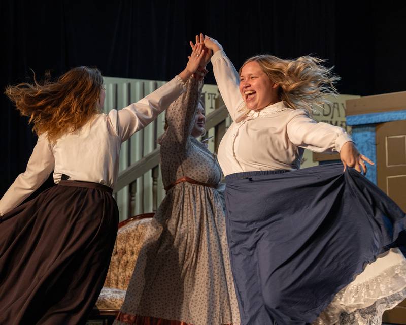 Beth March, played by Ivy Noelle (from left), Amy March, played by Paisley Smith, and Meg March, played by Ashley Hurst, dance on stage during a performance of 'Little Women' at Stage 212 in LaSalle.