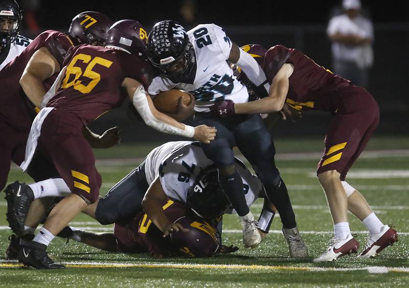 Woodstock North's David Randecker tries to bounce off the tackle attempt of Richmond-Burton's Trevor Szumanski during a Kishwaukee River Conference football game on Friday, Oct. 11, 2024, at Richmond-Burton High School.