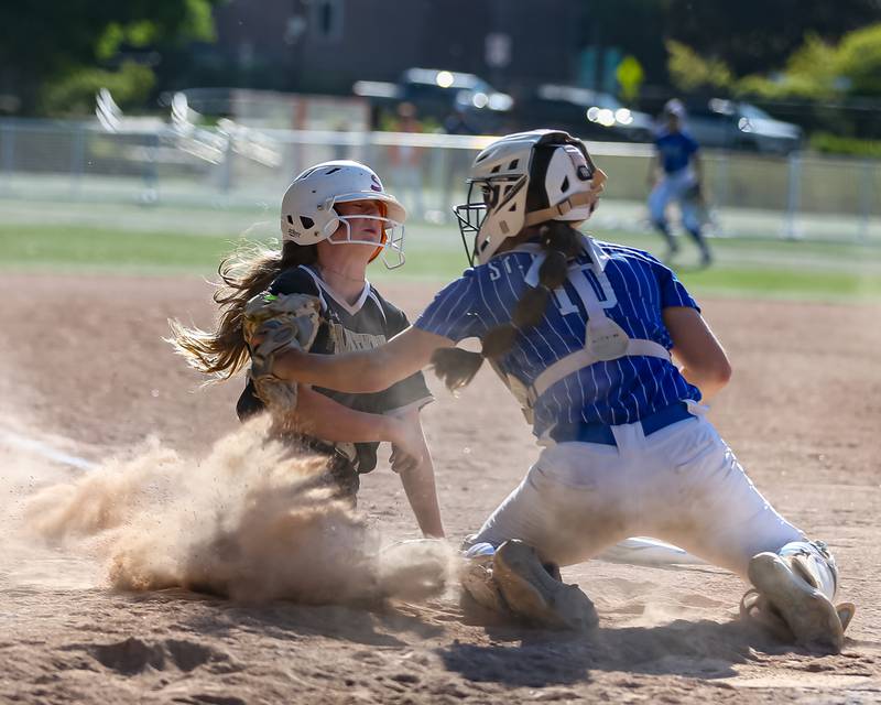 Glenbard North's Alyssa Abderhalden (13) is tagged out at the plate by St Charles North's Sophia Olman (10) during the Class 4A Glenbard West Regional Final softball game between Glenbard North at St Charles North.  May 26, 2023.