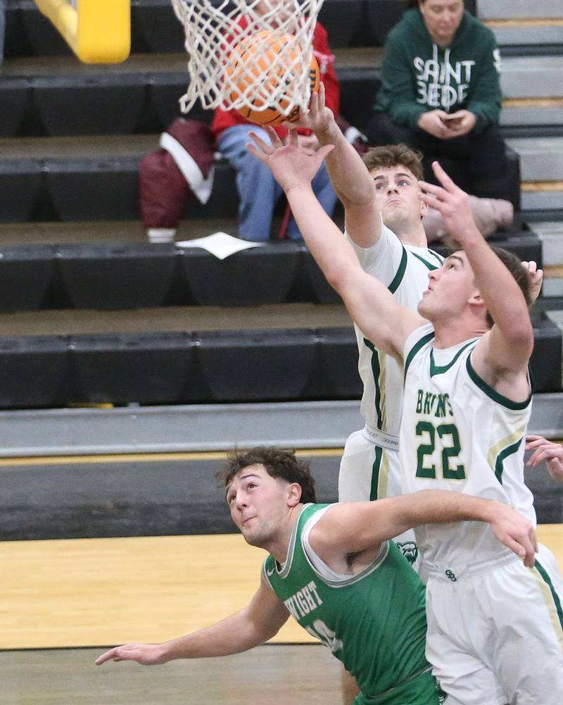 St. Bede's AJ Hermes grabs a rebound with the help of teammate Gus Burr over Dwight's Evan Cox during the Tri-County Conference Tournament on Tuesday, Jan. 27, 2026 at Putnam County High School.