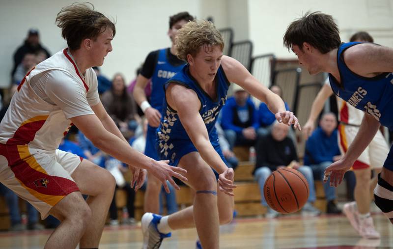Clifton Central's Jake Thompson, center, looks to recover a loose ball over St. Anne's Jason Bleyle, left, in the RVC Tournament Championship on Friday, Feb. 13, 2026.