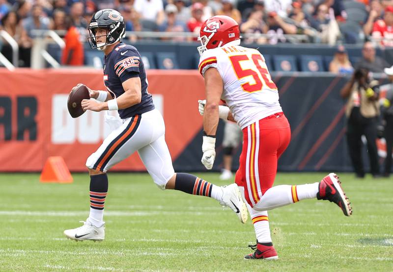 Chicago Bears quarterback Trevor Siemian runs away from the pressure of Kansas City Chiefs defensive end George Karlaftis during their preseason game Aug. 13, 2022, at Soldier Field in Chicago.