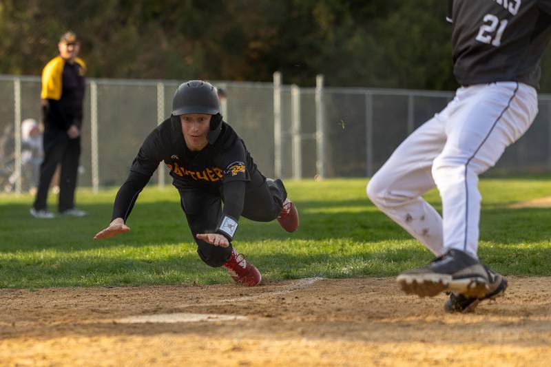 Maddox Poole (6) of Putnam County slides into home plate on Thursday, April 17, 2025 at Woodland High School in Streator.