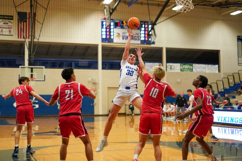 Geneva’s Benjamin Peterson (32) shoots the ball in the post over West Aurora's Kael Adkins (10) during a MLK Day of Hoops basketball game at Geneva High School on Monday, Jan. 20, 2025.