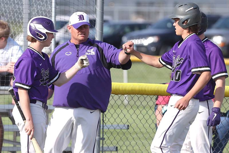 Dixon head coach Jason Burgess talks to his team during a break in the action during their game against Sycamore Thursday, May 19, 2022, at the Sycamore Community Sports Complex.