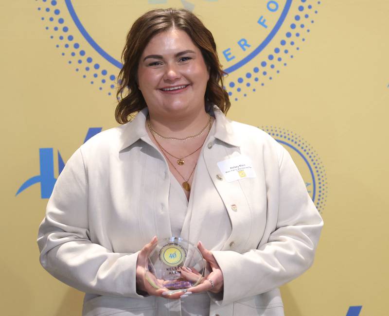Kelsey Klein poses with her 40 Under Forty award during the Illinois Valley Chamber of Commerce Champions of Change Awards Night on Wednesday, May 6, 2026 at the Westclox Event Center in Peru.