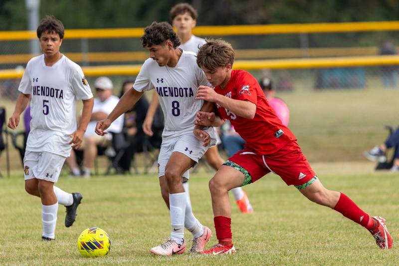 (from left) Mauricio Salinas (5) of Mendota stands by as teammate Ramiro Palacios (8) pushes ball upfield with Brenden Fleming (5) of Streator aggressively defending on Saturday, Aug 30, 2025 at the James Street Recreation Area in Streator.