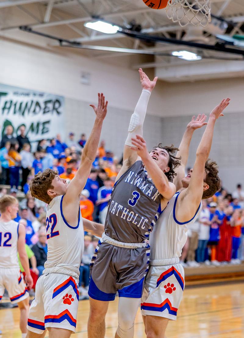 Newman junior Garret Matznick splits the Eastland defense for a layup during the second half of action at West Carroll on Friday, February 28, 2025.