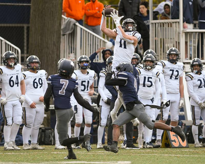 IC Catholic Prep's Grant Bowen (11) catches the ball while being defended by Chicago Hope Academy’s Carmen Cox (4) during the 3A Playoff game on Saturday Nov. 1, 2025, held at Altgeld Park in Chicago.