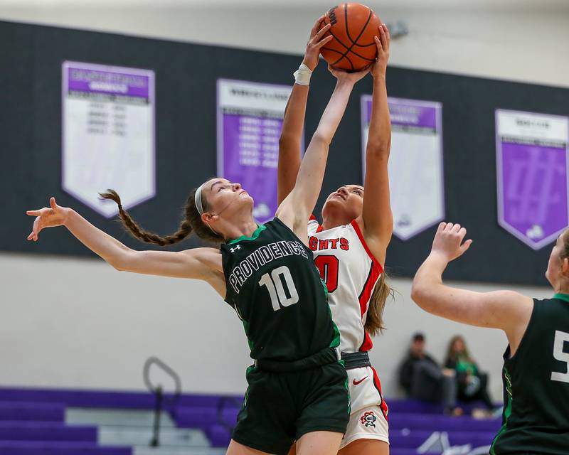 Providence's Molly Knight (10) battles Lincoln Way Central's Angelina Panos (30) for a rebound in the WJOL Tournament Championship game. Nov 18, 2023.