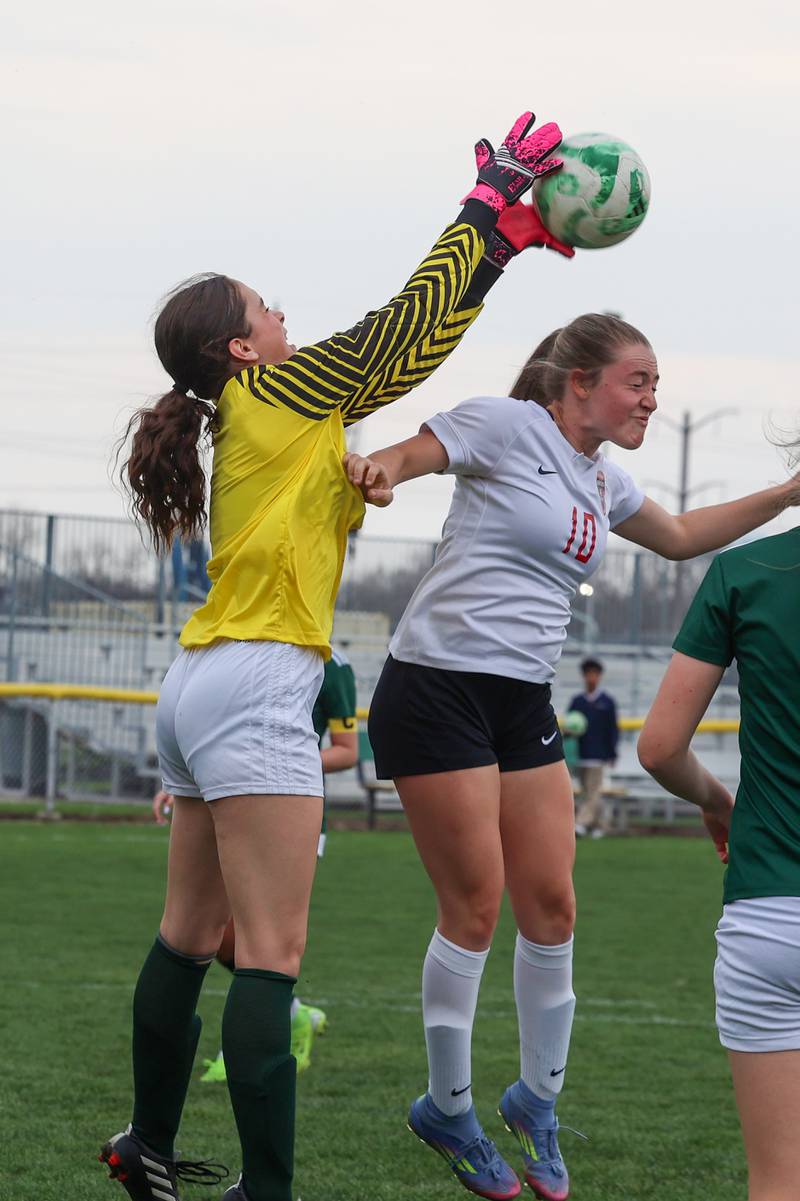 Bradley-Bourbonnais' Harper Tollefson goes for a header against Bishop McNamara goalkeeper Anna Manes during the Boilermakers' 9-1 win over Bishop McNamara in All-City play on Tuesday, March 31, 2026.