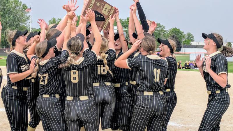 The Sycamore softball team celebrates with its plaque after beating Belvidere 10-0 in five innings on Friday, May 30, 2025, to win the Class 3A Freeport Regional.