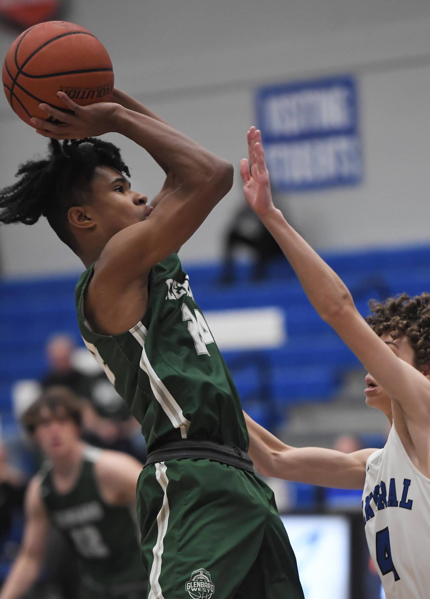 Glenbard West’s TJ Williams shoots over Burlington Central’s Ryan Carpenter in a boys basketball game in Burlington on Wednesday, Jan. 3, 2023.