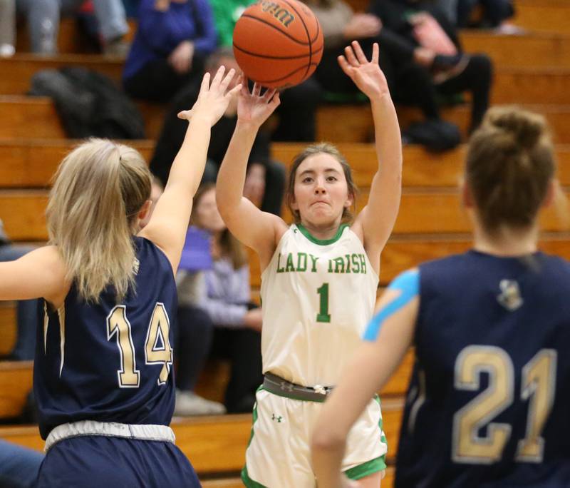Seneca's Alyssa Zellers shoots a three-point shot over Marquette's Eva McCallum and Avery Durdan during the Tri-County Conference Tournament on Tuesday, Jan. 17, 2023 at Midland High School.