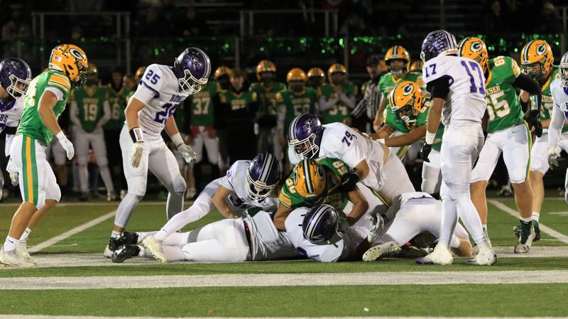 Rochelle's Nolan Johnson, Gavin Neale, and Tyler Gensler on the bottom and Luke Chadwick and Dane Ferguson converge for a tackle during Friday's game in Rochelle.