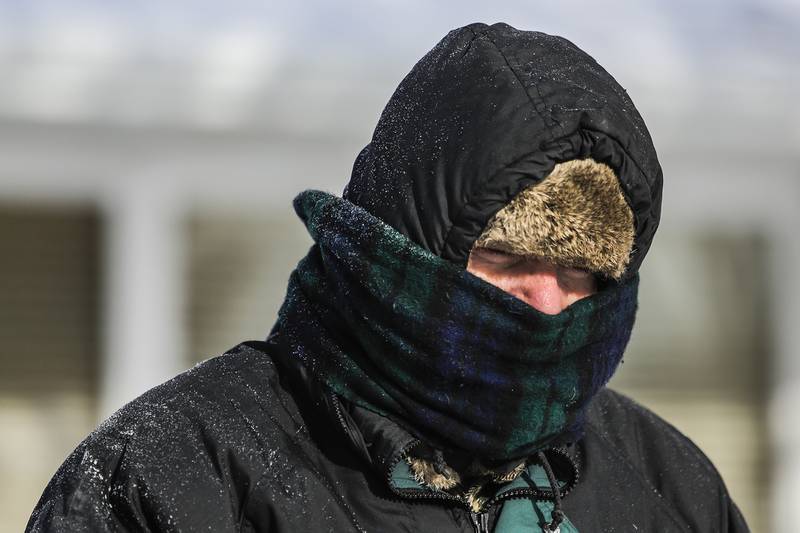 Gerald Gear uses a snow blower to clear snow from his driveway in Joliet on Monday. Extreme cold temperatures covered parts of the mid west for the second time this month.