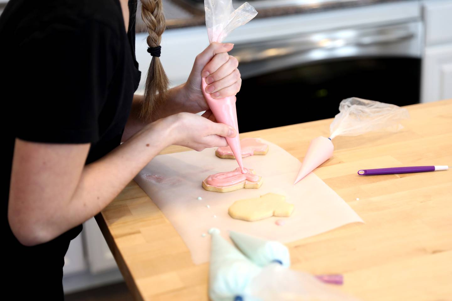 Alyssa Altman, 20, makes cookies for a gender reveal party in the kitchen of her Geneva home. Altman started a cookie business during the Covid-19 pandemic when she was a junior in high school. Now a junior at Northern Illinois University, she continues to bake.