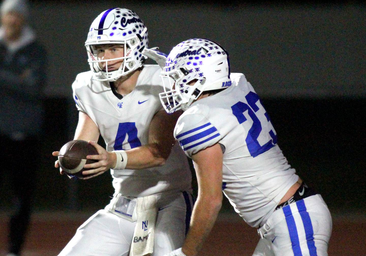 Burlington Central’s Zachary Samaan, right, takes a handoff from Jackson Alcorn in varsity football at Huntley High School in Huntley on Friday, Oct. 25, 2024.