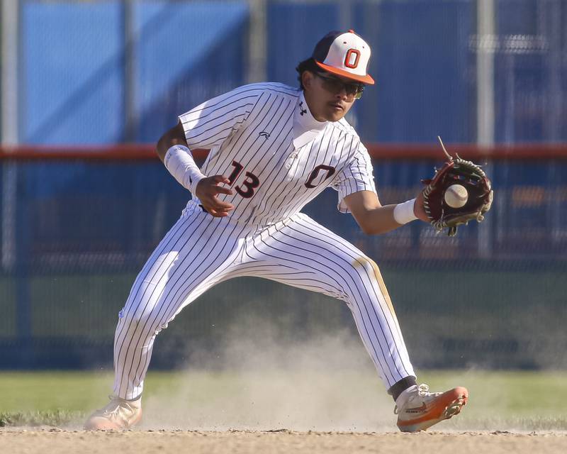 Oswego's Kevin Camacho (13) fields a hopper during baseball game Oswego East at Oswego.  May 14, 2026 in Oswego.