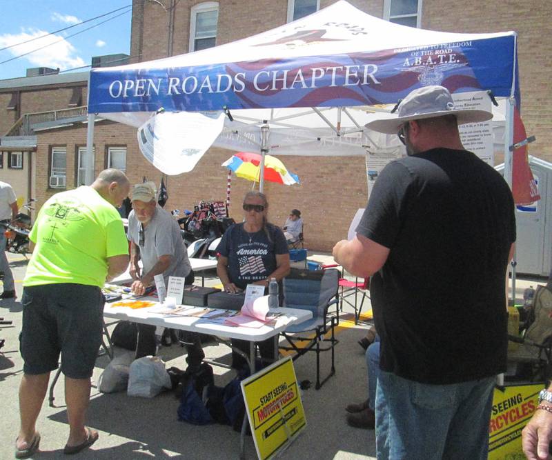 Pictured are Open Roads ABATE members Bill and Sally Kolb helping booth visitors to fill out raffle tickets.