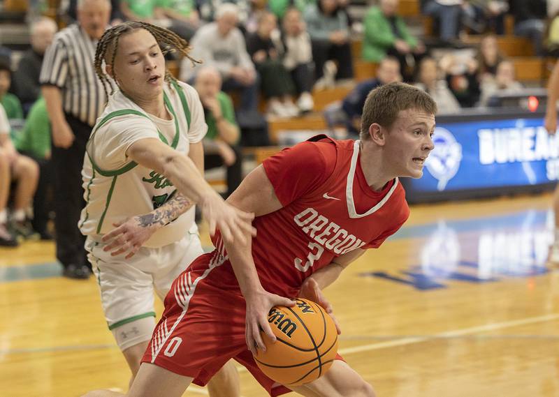 Rock Falls’ Nehemiah Menendez reaches for the ball handled by Oregon’s Cooper Johnson Wednesday, Feb. 26, 2025, at the Class 2A Regional semifinal at Bureau Valley High School.