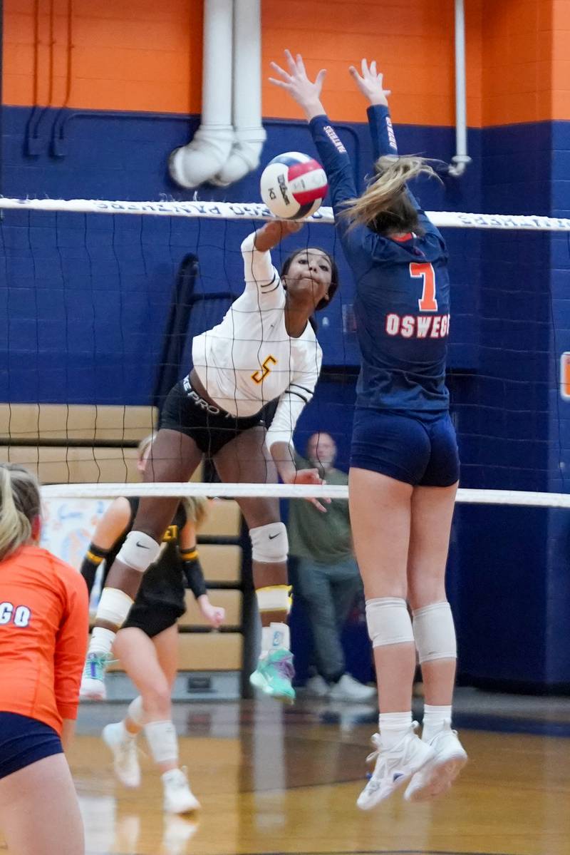 Joliet West's Madyson Gant (5) goes up for a kill attempt against Oswego’s Hannah Herrick (7) during a volleyball match at Oswego High School on Thursday, October 24, 2024.