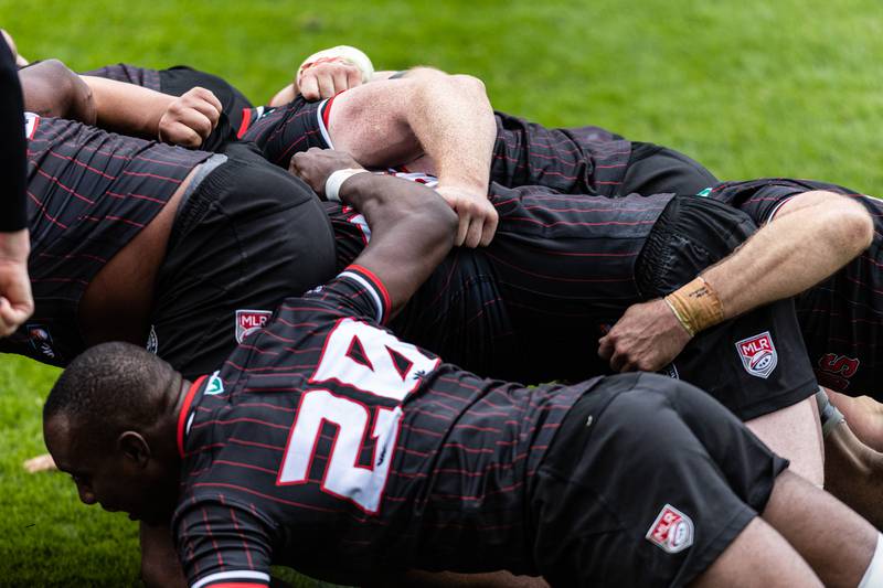 Chicago Hounds players lock arms in a scrum during a game against NOLA Gold, at Seat Geek Stadium in Bridgeview, on Sunday April 23, 2023.