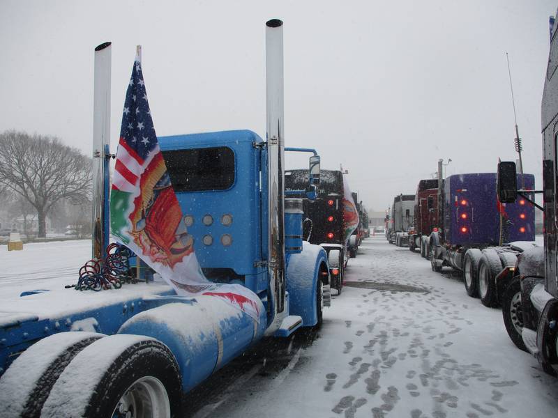 Truck cabs line up in the parking lot outside of Our Lady of Mount Carmel Church on Jackson Street in Joliet before departing on a pilgrimage on Saturday. Nov. 29, 2025