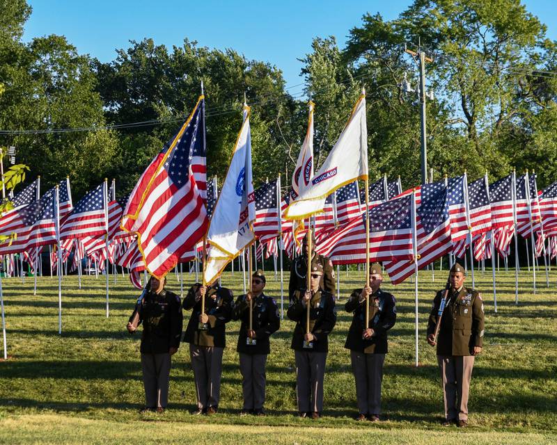 Chicago Recruiting Battalion, U.S. Army, stand at attention outside of The Field of Honor that is displaying 500 American Flags to honor veterans, active military, first responders as well as frontline workers on Sunday Sep. 3, 2023, at Denning Park in La Grange.