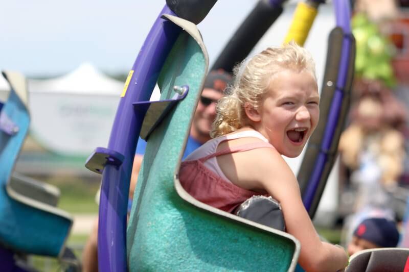 Addison Baiser, 7, of St. Louis takes a spin on the Tornado ride during Fiesta Days at Petersen Park in McHenry Sunday. Addison was in town visiting her grandparents who live in McHenry.