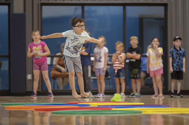Conor Plemmons hops through hoops at the Kids Table in Dixon Park District’s The Facility Wednesday, May 31, 2023. After making slime and ice cream, the kids burned off energy in the gym.