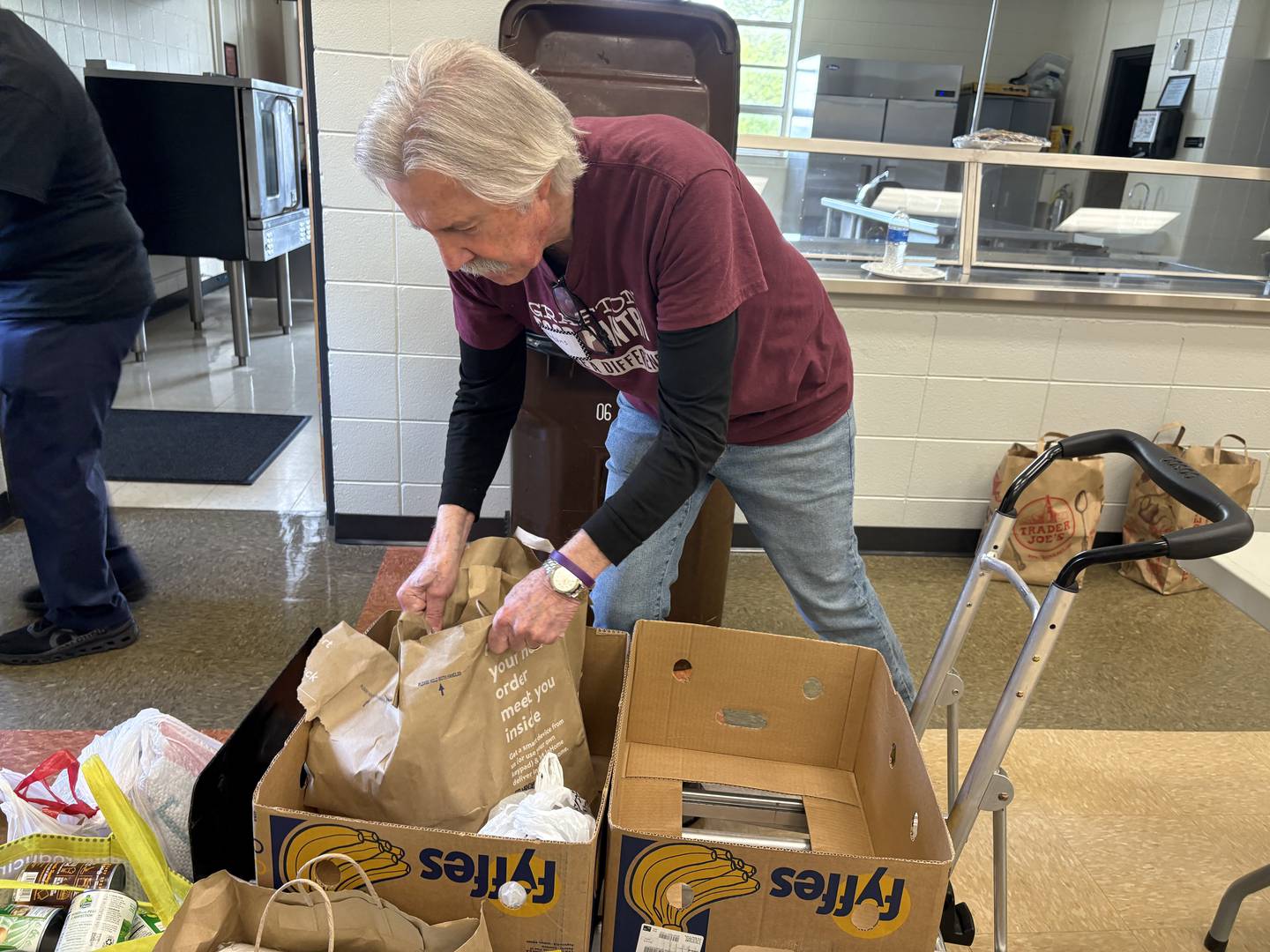 Grafton Food Pantry Volunteer Hans Stucki grabs bags of food at the Huntley Park District Saturday May 9, 2026.