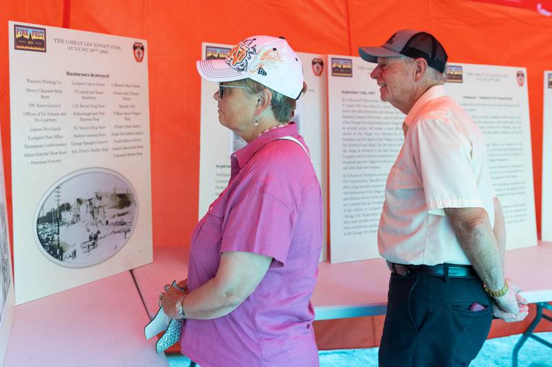 Lockport residents Diana and Steve Johnson read about The Great Lockport Fire during Fire Fest in Lockport on August 10, 2024.
