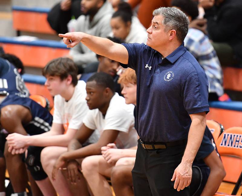 Oswego East boys basketball coach Ryan Velasquez reacts to action on the court during a Hoops for Healing tournament game against West Aurora on Nov. 20, 2023 at Naperville North High School in Naperville.