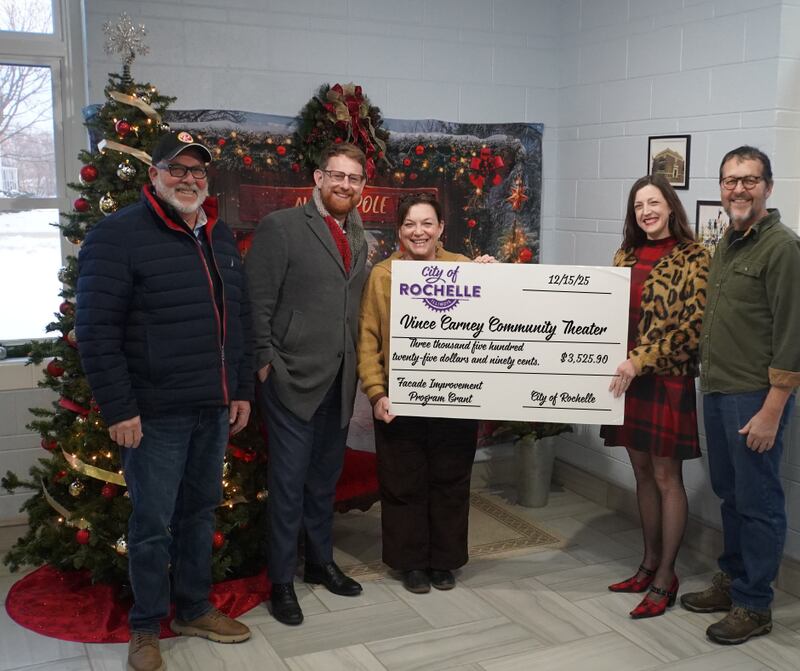 From left to right: City of Rochelle Mayor John Bearrows, Finance Director Matt Hoffman and Community Development Director Michelle Pease present a grant to Amy and Steve Frank of the Vince Carney Community Theater on Monday, Dec. 15, 2025.