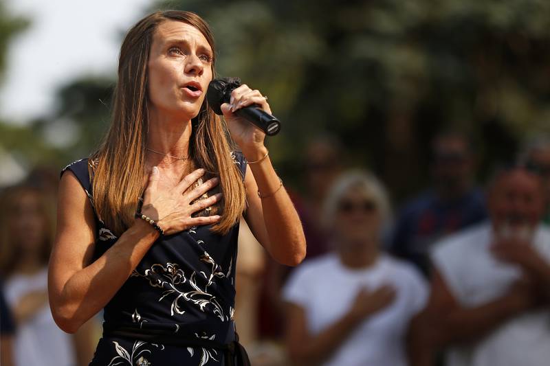 Dana Robinson sings the National Anthem during a Patriots Day remembrance for the 20th anniversary of the terrorist attacks of 9/11 on Saturday, Sept. 11, 2021 at Union Cemetery in Crystal Lake.