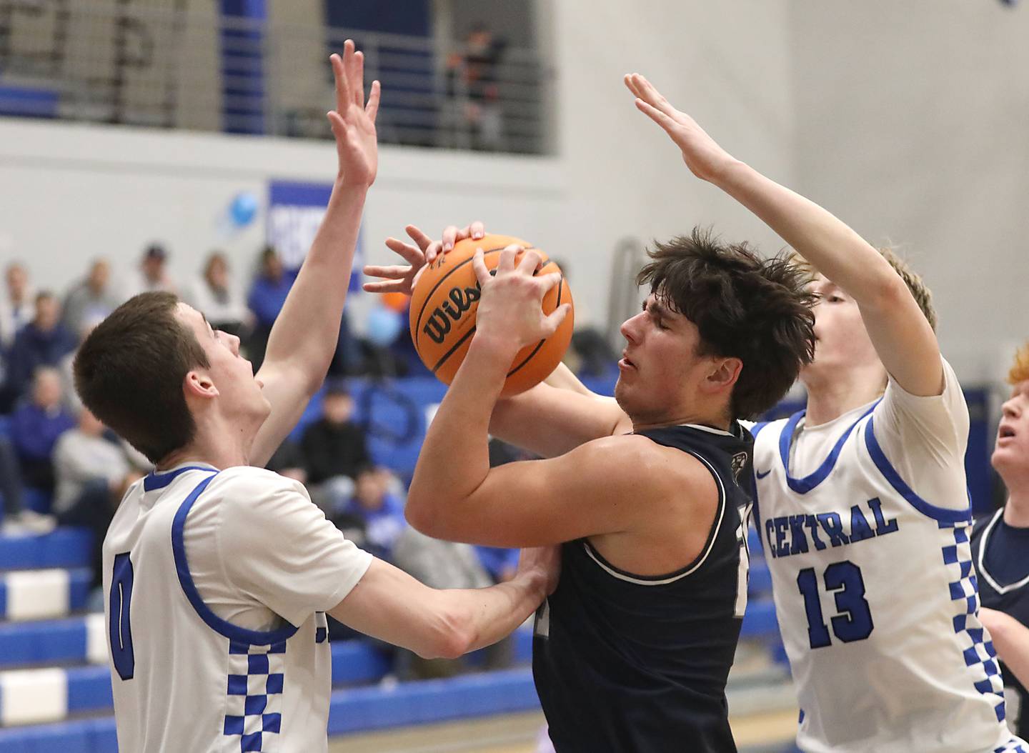Cary-Grove's Brady Elbert tries to drive between Burlington Central's Patrick Magan (left) and eclan Wilson (right) during a Fox Valley Conference boys basketball game on Friday, February. 6, 2026, at Burlington Central High School.