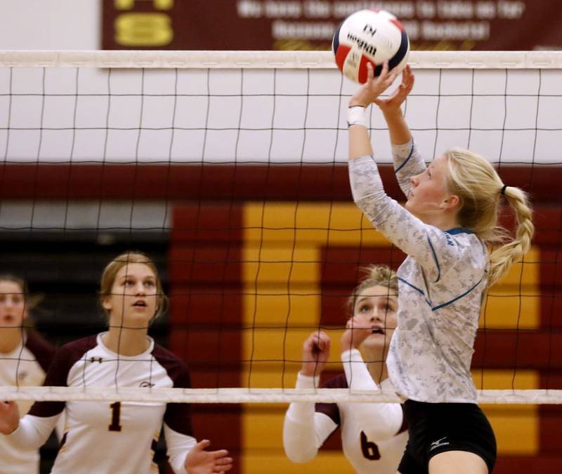 Woodstock North's Kylie Schulze, right,  sets the ball as Richmond-Burton's Madi Havlicek, left, and Elissa Furlan, center, look to were the ball is going during a Kishwaukee River Conference volleyball match Wednesday, Sept. 14, 2022, between Richmond-Burton and Woodstock North at Richmond-Burton Community High School.
