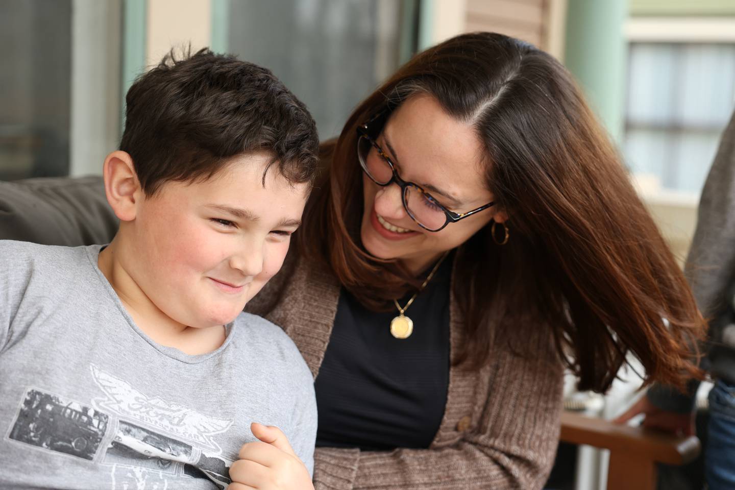 Emily Brzycki plays with her son Max on the front porch of their home in Joliet. Friday, April 15, 2022, in Joliet.