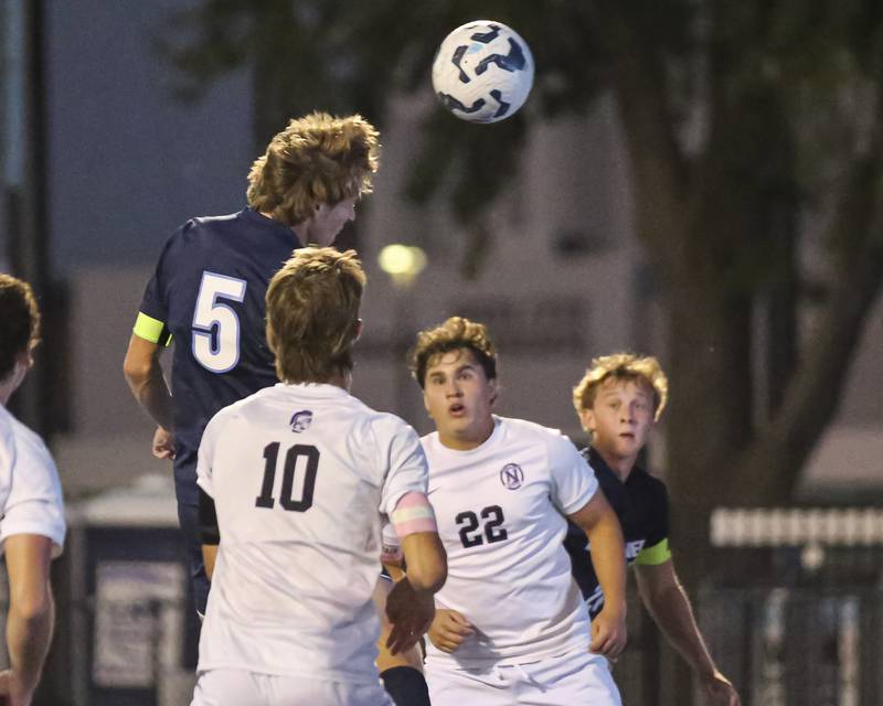 Downers Grove South's Brady Dunlap (5) heads a shot on goal during soccer match between Downers Grove North at Downers Grove South. Oct 2, 2025.
