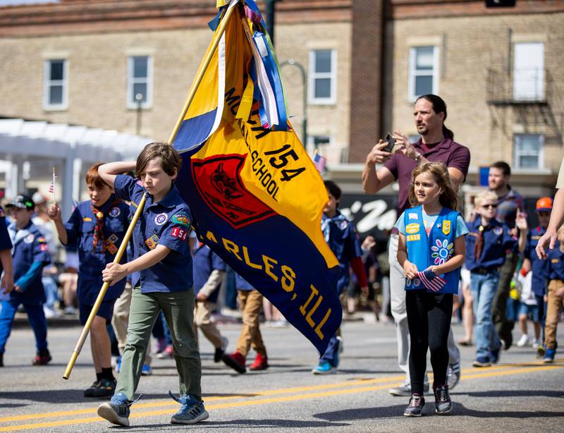 Scouts from Pack 154 march during the St. Charles Memorial Day Parade in downtown St. Charles on Monday, May 26, 2025.