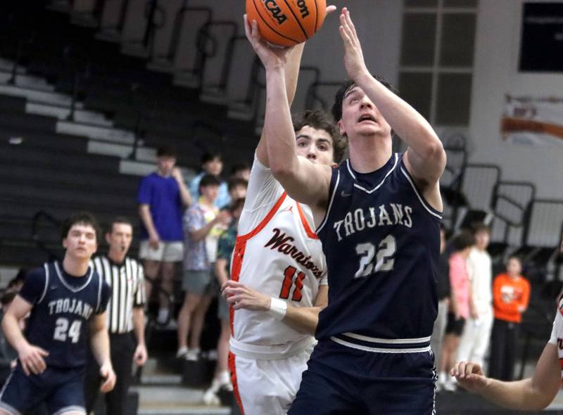 McHenry’s Haydn Schmidt, left, guards Cary-Grove’s Adam Bauer under the hoop in varsity boys basketball on Tuesday, Feb. 17, 2026, at McHenry High School in McHenry.