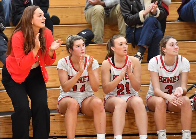 Benet assistant coach Brooke Schramek (left), a former star basketball player for the Redwings, reacts to a score during a game on November 18, 2025 at Benet Academy in Lisle.