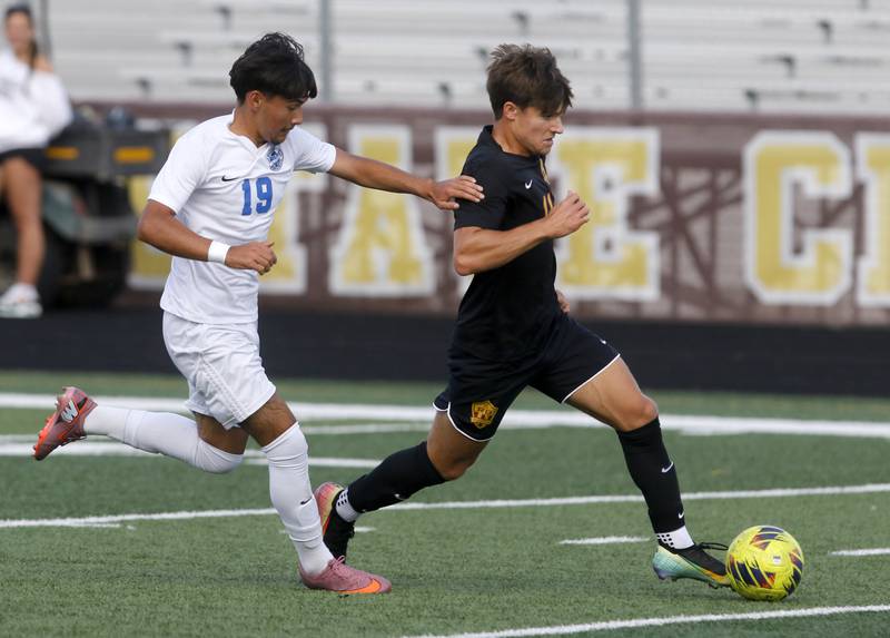 Woodstock's Christopher Flores tries to slow down Richmond-Burton’s Nick Kyes as he heads towards the goal during a Kishwaukee River Conference soccer match on Wednesday, Sept. 10, 2025, at Richmond-Burton High School, in Richmond.