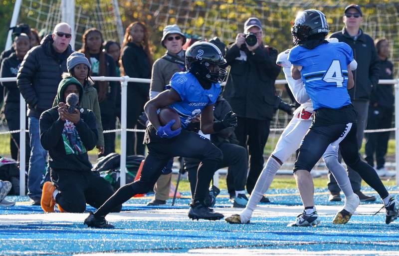 St. Francis' Ian Willis (2) runs after the catch against Morgan Park during a class 5A state quarterfinal football game at St. Francis High School in Wheaton on Saturday, Nov 11, 2023.