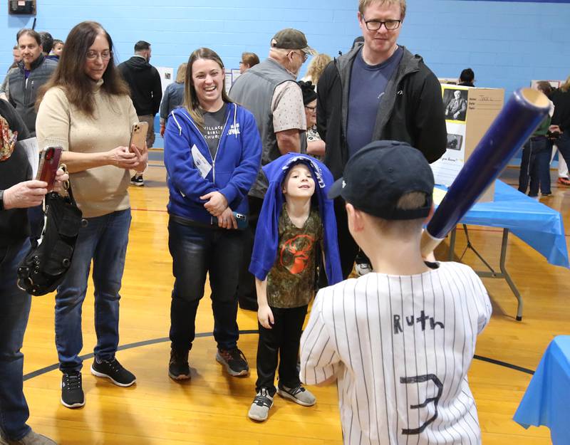Visitors listen to third grader Jonah DeGroot, who is portraying Babe Ruth, as he gives his presentation during the Hinckley Big Rock Elementary School Wax Museum Thursday, March 13, 2025, at the school in Hinckley.