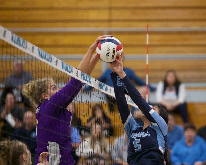 Downer's Grove North's Jenny Buechler goes for the block against Downers Grove South's Alex Barcenas at the Class 4A Willowbrook Sectional Final on Thursday, Nov.7,2024 in Villa Park.