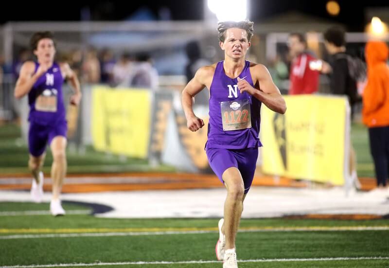 Downers Grove North’s Philip Cupial takes first place in the boys varsity race during the Naperville North Twilight Cross Country Invitational on Wednesday, Oct. 9, 2024 in Naperville.