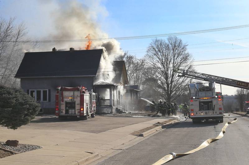 Firefighters work the scene of a fully engulfed house fire in the 800 block of Bucklin Street on Friday, Jan. 23, 2026 in La Salle.