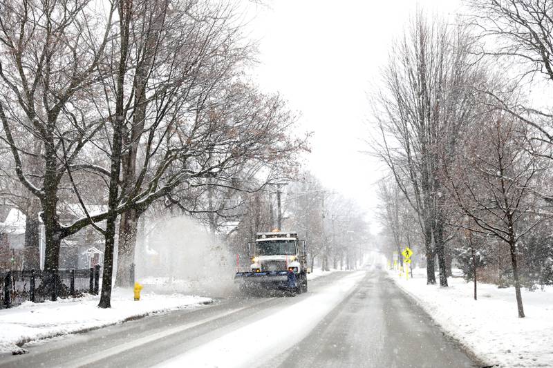 A plow truck clears streets of snow in Downers Grove during a snowstorm on Tuesday, Jan. 9, 2024.